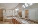 Luxurious bathroom with double vanity, soaking tub, and tiled walk-in shower at 20590 Granlago Dr, Venice, FL 34293
