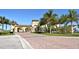 Grand community entrance showcasing beautiful architecture, landscaping, and inviting atmosphere with palm trees at 20590 Granlago Dr, Venice, FL 34293