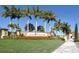 Elegant entrance sign for Gran Paradiso, with palm trees and colorful flowers, inviting residents and guests at 20590 Granlago Dr, Venice, FL 34293