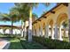 Exterior building with arches, columns, lush landscaping and brick paved driveway at 20590 Granlago Dr, Venice, FL 34293