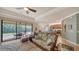 Open-concept living room with tropical decor, patio access, and view to kitchen at 20590 Granlago Dr, Venice, FL 34293