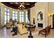 Elegant living room with large windows, fireplace, and stylish furnishings for sophisticated living at 20590 Granlago Dr, Venice, FL 34293