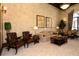 This living room has a beautiful neutral color palette, art, comfortable seating and warm lighting at 20590 Granlago Dr, Venice, FL 34293