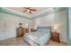 Bright main bedroom with tray ceiling, dresser, and ensuite bathroom at 20590 Granlago Dr, Venice, FL 34293