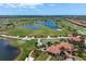 Aerial view of community with golf course and lake at 23499 Awabuki Dr # 102, Venice, FL 34293