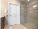 Bathroom with a large walk-in shower and a single white door at 23499 Awabuki Dr # 102, Venice, FL 34293