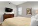 Spacious bedroom with a dresser, large bed, and window at 23499 Awabuki Dr # 102, Venice, FL 34293