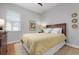 Bright bedroom with a queen-size bed and wood flooring at 23499 Awabuki Dr # 102, Venice, FL 34293