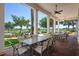 Covered patio with multiple tables and chairs overlooking the golf course at 23499 Awabuki Dr # 102, Venice, FL 34293