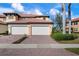 Two-car garage and brick paver driveway at 23499 Awabuki Dr # 102, Venice, FL 34293