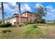 Attractive exterior with landscaping and lake view at 23499 Awabuki Dr # 102, Venice, FL 34293