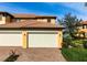 Three-car garage with brick paver driveway at 23499 Awabuki Dr # 102, Venice, FL 34293