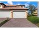 Two-car garage with brick paver driveway at 23499 Awabuki Dr # 102, Venice, FL 34293