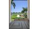 View of a lush green golf course from a covered patio area at 23499 Awabuki Dr # 102, Venice, FL 34293