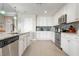 Spacious kitchen featuring stainless steel appliances and white cabinetry at 23499 Awabuki Dr # 102, Venice, FL 34293
