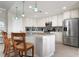 Modern kitchen with granite countertops, white cabinets, and stainless steel appliances at 23499 Awabuki Dr # 102, Venice, FL 34293