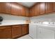 Laundry room with ample cabinetry and modern appliances at 23499 Awabuki Dr # 102, Venice, FL 34293