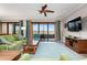 Living room with large TV and lake view at 23499 Awabuki Dr # 102, Venice, FL 34293