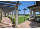 Walkway with pergola offering scenic views of a golf course at 23499 Awabuki Dr # 102, Venice, FL 34293