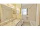Clean bathroom with bathtub, vanity, and mirror at 237 Venice East Blvd, Venice, FL 34293