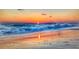 Stunning sunset over the ocean with waves on the sandy beach at 237 Venice East Blvd, Venice, FL 34293