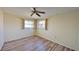 Bright bedroom with ceiling fan and wood-look floors at 237 Venice East Blvd, Venice, FL 34293