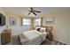 Cozy bedroom featuring a queen-sized bed, ceiling fan, and complementary decor for a relaxing atmosphere at 237 Venice East Blvd, Venice, FL 34293