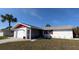 Front view of a single-story house with a garage and screened porch at 237 Venice East Blvd, Venice, FL 34293