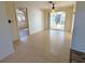 Open living area with tile and laminate wood flooring, and view into other rooms at 237 Venice East Blvd, Venice, FL 34293