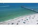 Aerial view of beach with pier, parasailing, and swimmers at 249 Rio Terra, Venice, FL 34285