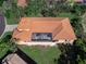 Top-down view of a home with a screened-in patio and tile roof at 249 Rio Terra, Venice, FL 34285