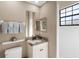 Clean bathroom with granite vanity, a large mirror, and a shower at 249 Rio Terra, Venice, FL 34285