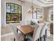 Elegant dining room with wood table, upholstered chairs, and large windows at 249 Rio Terra, Venice, FL 34285