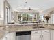 Kitchen features granite countertops and a breakfast bar overlooking the Gathering room at 249 Rio Terra, Venice, FL 34285