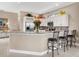 Kitchen with granite countertops, white cabinets, and breakfast bar at 249 Rio Terra, Venice, FL 34285