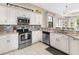 Spacious kitchen with stainless steel appliances and granite countertops at 249 Rio Terra, Venice, FL 34285