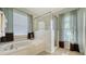 Spa-like bathroom with soaking tub and walk-in shower at 250 Long Meadow Ln, Rotonda West, FL 33947