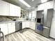 Modern kitchen with stainless steel appliances and white cabinets at 262 Mariner Dr, North Port, FL 34287