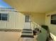Mobile home entryway with steps and patio furniture at 269 Outer Dr, Venice, FL 34285
