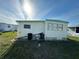Mobile home exterior with a grassy yard at 269 Outer Dr, Venice, FL 34285
