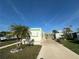 Single-wide manufactured home with carport and palm tree at 269 Outer Dr, Venice, FL 34285
