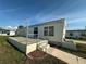 Mobile home exterior with steps leading to the entrance at 269 Outer Dr, Venice, FL 34285
