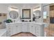 Modern bathroom with double vanity, large mirrors, and a separate tub and shower at 3162 Cordova Ter, North Port, FL 34291