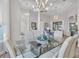 Formal dining area with a glass-top table and neutral-toned chairs at 3162 Cordova Ter, North Port, FL 34291