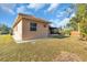 Tan house with tile roof, driveway, and landscaped lawn at 3162 Cordova Ter, North Port, FL 34291