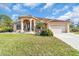 Tan house with tile roof, columns, and a two car garage at 3162 Cordova Ter, North Port, FL 34291