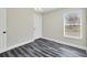 Simple bedroom with wood-look floors and window at 3255 Tupelo Ave, North Port, FL 34286