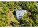 Overhead view of a large home with a pool, set within a private, wooded estate at 340 N River Rd, Venice, FL 34293