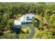 Expansive estate surrounded by lush greenery, showcasing the home's privacy and generous lot size at 340 N River Rd, Venice, FL 34293
