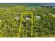 A large wooded lot with a house nestled inside, indicated by yellow boundary lines for property definition at 340 N River Rd, Venice, FL 34293